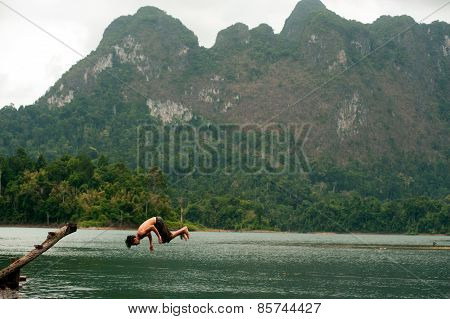 Tourists Fun Jumping Water In Cheow Larn Lake (ratchaprapa Dam),Thailand.