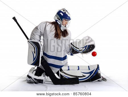 Young ball hockey goalie makes a save.