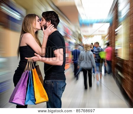 Happy Kissing Couple With Shopping Bags