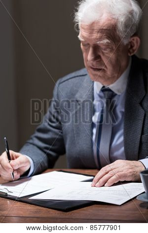 Aged Businessman Doing Paperwork