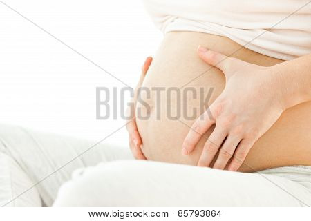 Pregnant woman holding stomach