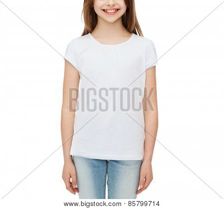 advertising and t-shirt design concept - smiling little girl in white blank t-shirt over white background