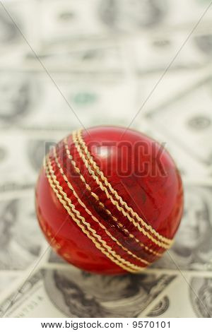 Red Cricket Ball and Money