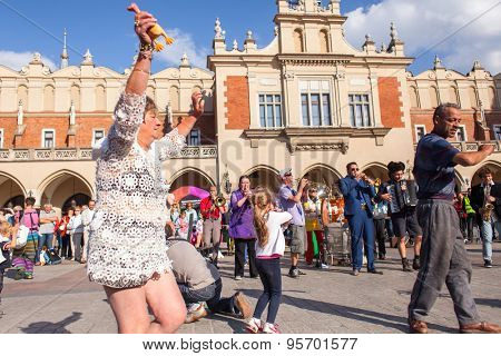 KRAKOW, POLAND - JUL 11, 2015: Participants at the annually (July 9-12) 28th International Festival of Street Theatres - Orchestre International du Vetex (Belgium/France) in the Main Square of Krakow.