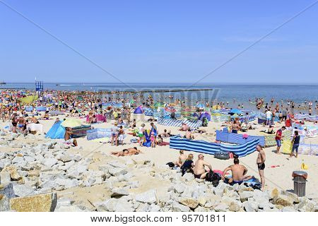 USTKA - JULY 04: Tourists enjoy the sunny weather and relaxing on the Baltic sea beach on 04 July 2015 in Ustka, Poland.