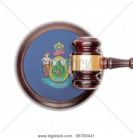 Wooden judge gavel with US state flag on sound block - Maine