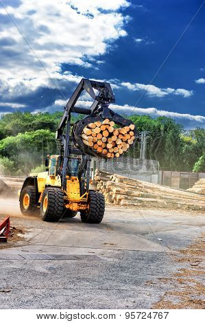 Forklift Truck Hauling Logs At Sawmill