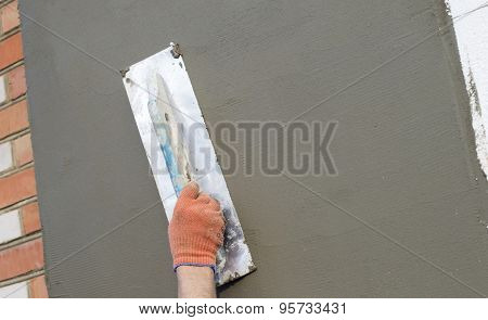 The Process Of Applying Putty With A Spatula