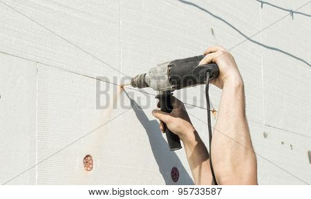 The Process Of Drilling Holes In The White Polyfoam