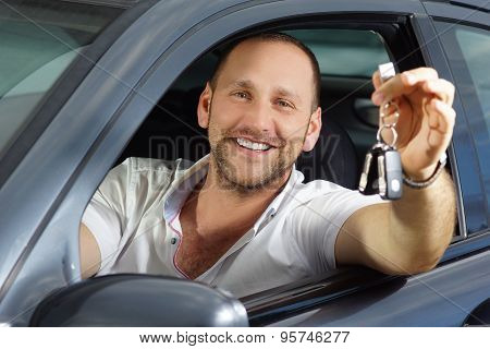 Happy new car owner smile into camera with car keys