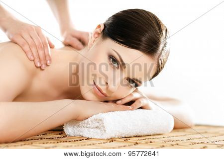 Young and healthy woman in spa salon. Traditional Swedish massage therapy and beauty treatments. 