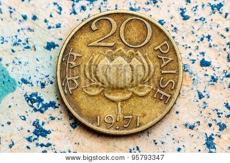 Antique Indian 20 paise coin depicting lotus flower on a plain background