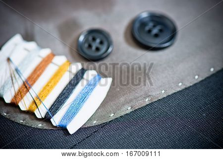 detail of sewing kit on the gray clothing