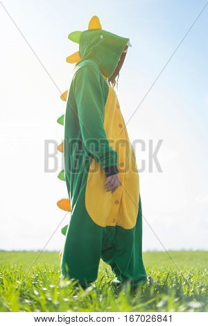 Dragon kigurumi on the green fild, girl
