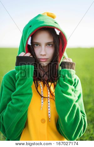 Dragon kigurumi on the green fild, girl, portrait
