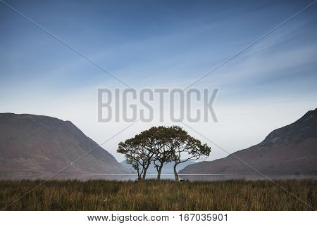 Beautiful Foggy Misty Autumn Sunrise Over Countryside Surrounding Crummock Water In Lake District In
