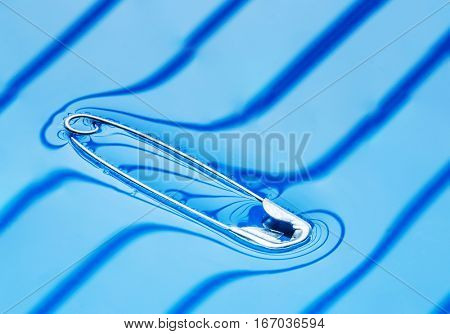 Physical experiment - pin floating on water surface.