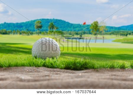 Golf ball on sand bunker in golf courses