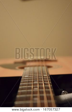 photo of a guitar with just the neck in foucs