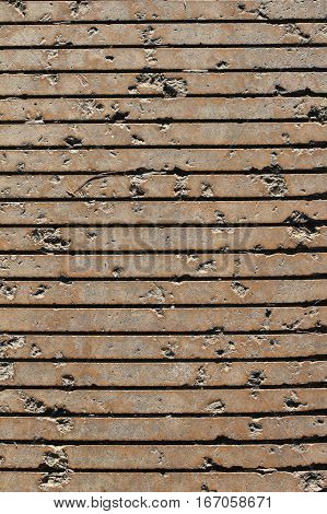 pavement with horizontal grooves and pits viewed directly