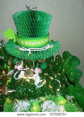 Lighted Saint Patrick's Day decorations feature green shamrocks garland carnations gold clover Irish top hat whimsical mice with blarney stone.