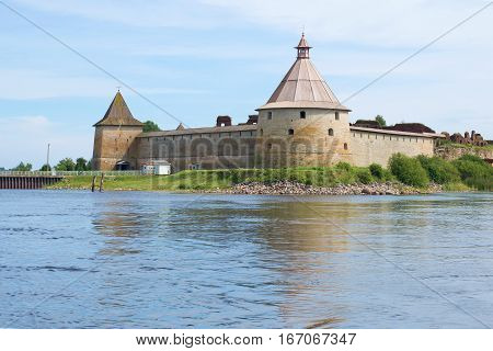 The old Golovin's tower and Monarchic tower of fortress Oreshek in the August afternoon. View from the water area of Neva. Russia