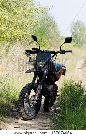 One pit bike is on a dirt road