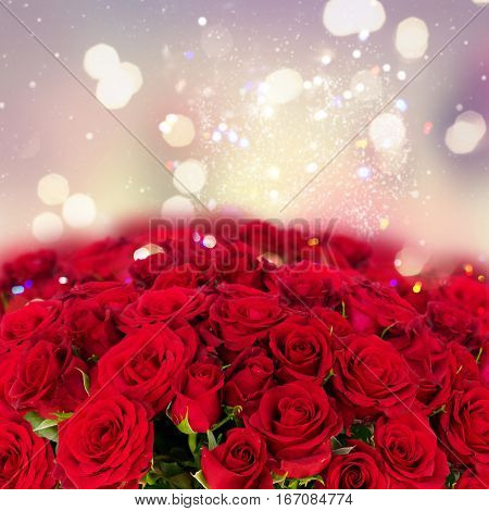 Bouquet of fresh dark red rose buds with over bokeh fesive background