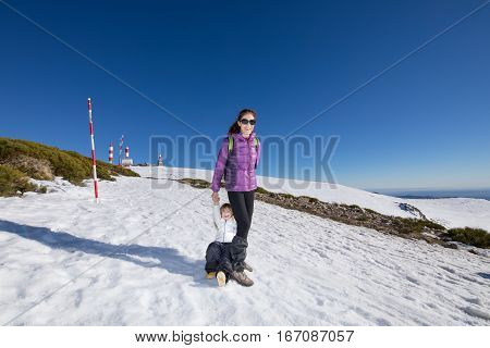 Mother And Child Smiling In Snow Mountain Summit