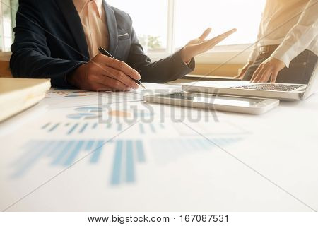 Business concept. Business people discussing the charts and graphs showing the results of their successful teamwork.