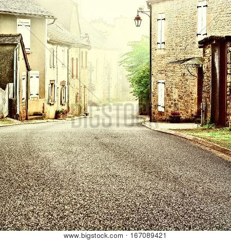 French Village Street in the Morning Mist Vintage Style Toned Picture