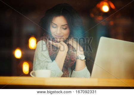 young beautiful woman visionary in cafe at laptop