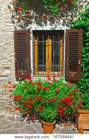 Italian Window with Open Wooden Shutters Decorated With Fresh Flowers