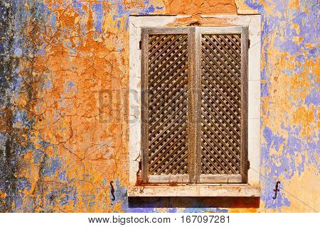 Window on the Peeling Facade of the Old Portugal House
