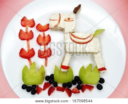 creative breakfast food with fruit and chocolate sweet cream on bread
