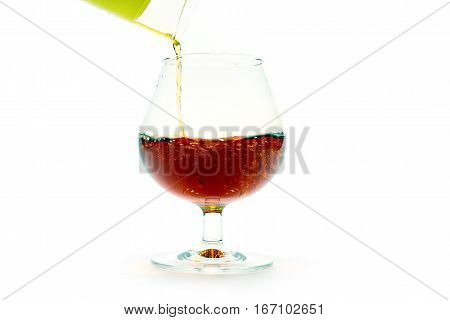 strong alcoholic drink containing alcohol is poured into a glass for consumption food