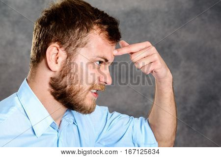 Bearded Man Looking Angry And Showing Bats In The Belfry