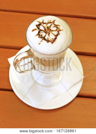 Latte macchiato with cocoa powder in the form of flower