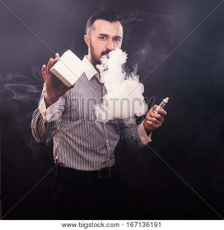 Vaping Man Holding A Mod And Box