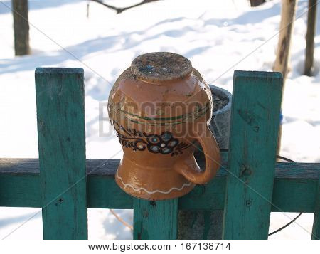 ceramic glechik upside-down weighs on the fence