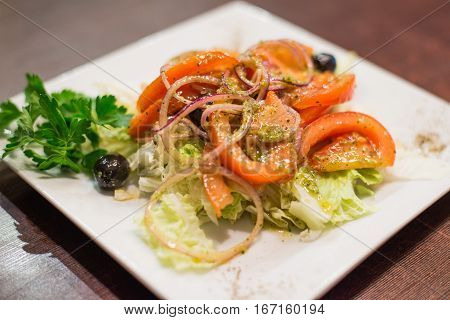 delicious greek salad dressed with olive oil