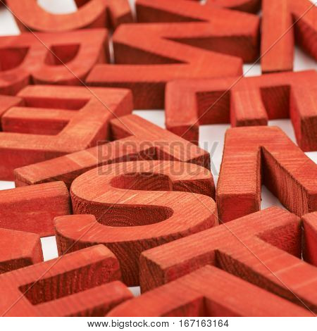Surface coated with the multiple painted wooden block letters as an abstract backrop composition