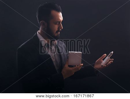Vaping Man Holding A Mod And Box Of Vaponizer.