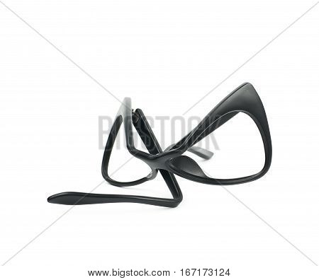 Heavily broken, bent and deformed pair of black plastic sight glasses isolated over the white background