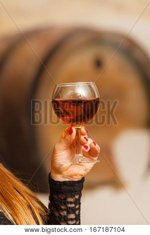 Woman Tasting Wine In Rural Cottage Interior