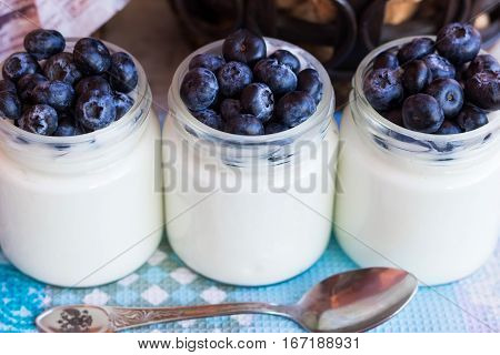 Homemade yogurt with blueberries in a glass jar