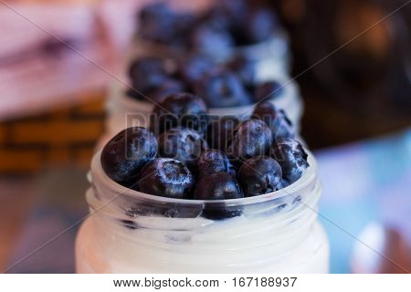 Homemade yogurt with blueberries in a glass jar