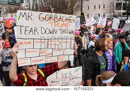 ATLANTA, GA - JANUARY 2017:  A woman carries a sign that says 