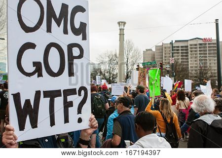 ATLANTA, GA - JANUARY 2017:  A woman holds a sign that says 
