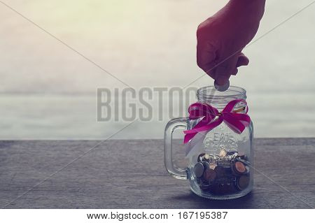 hand put money coin deposit of save money for prepare in the future.